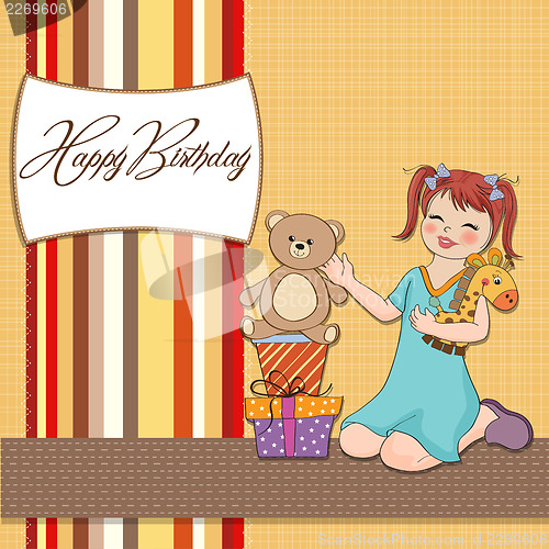 Image of little girl playing with her birthday gifts . happy birthday car