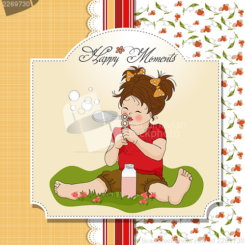 Image of funny lovely little girl blowing soap bubbles