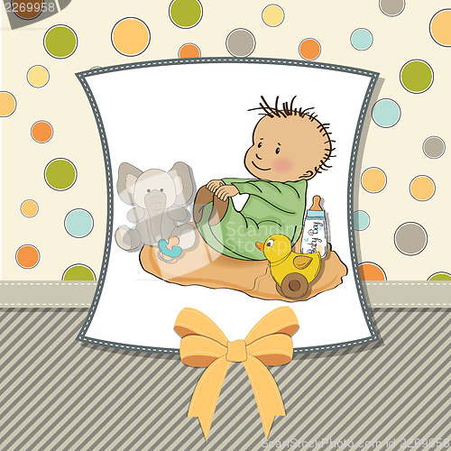 Image of little baby boy play with his toys