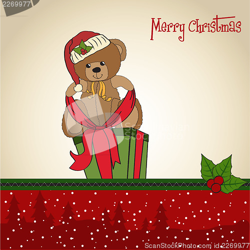 Image of cute teddy bear with a big Christmas gift box