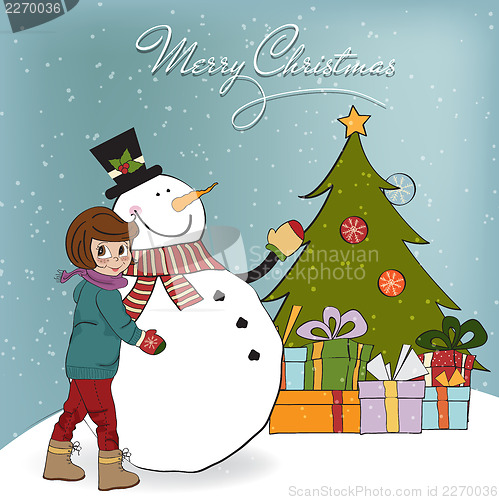 Image of Cute little girl with snowman