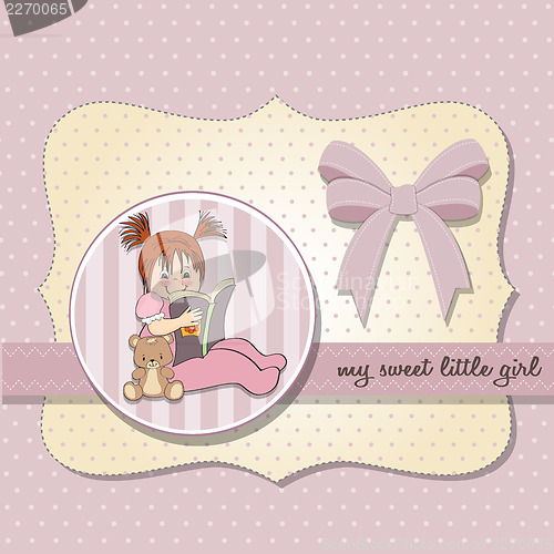 Image of sweet little girl reading a book