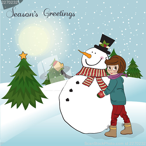 Image of Cute little girl with snowman