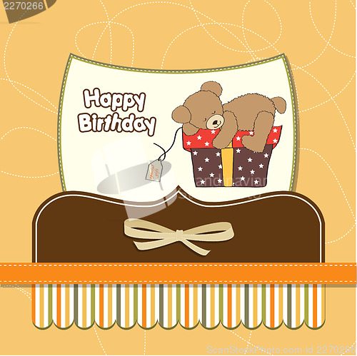 Image of birthday greeting card with teddy bear and big gift box