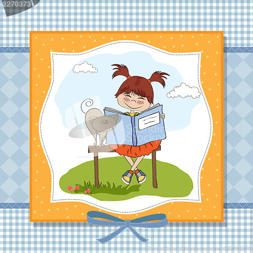 Image of young sweet girl reading a book