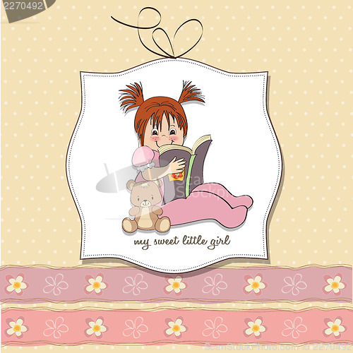 Image of sweet little girl reading a book