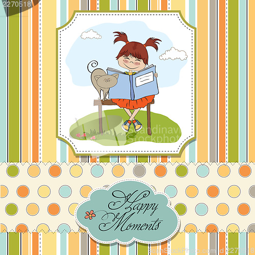 Image of young sweet girl reading a book