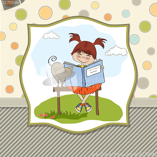 Image of young sweet girl reading a book