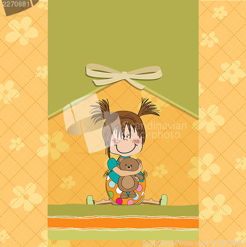 Image of little girl sitting with her teddy bear