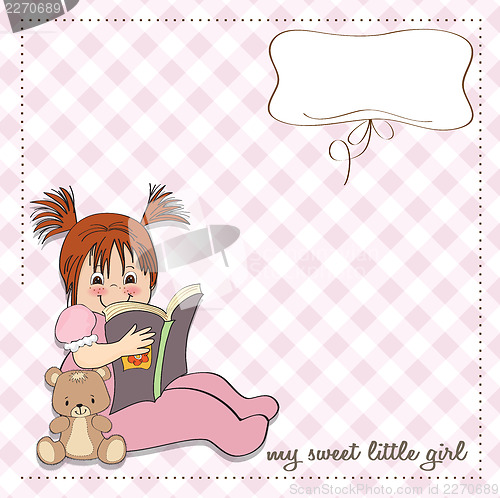 Image of sweet little girl reading a book