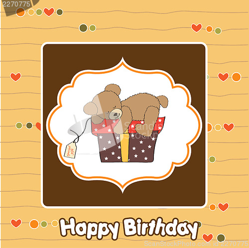 Image of birthday greeting card with teddy bear and big gift box
