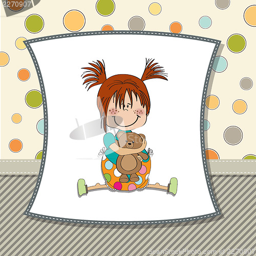 Image of little girl sitting with her teddy bear
