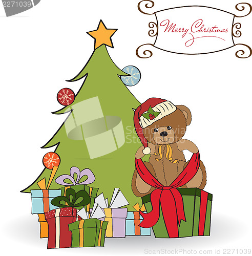 Image of cute teddy bear with a big Christmas gift box