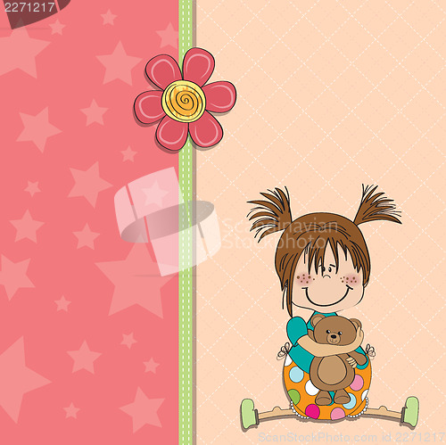 Image of little girl sitting with her teddy bear