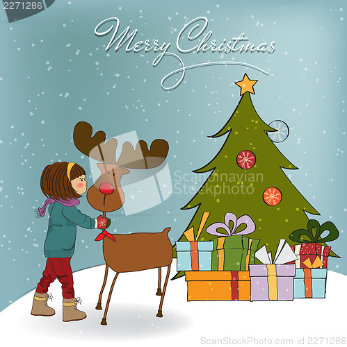 Image of Christmas card with cute little girl caress a reindeer