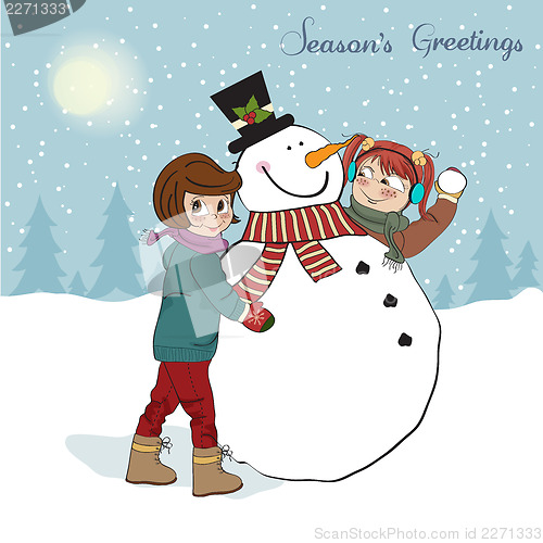 Image of two happy girls building a snowman