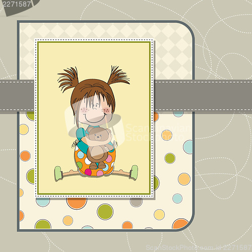 Image of little girl sitting with her teddy bear