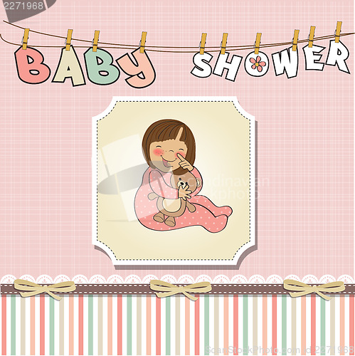 Image of little baby girl play with her teddy bear toy