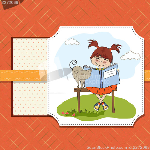 Image of young sweet girl reading a book