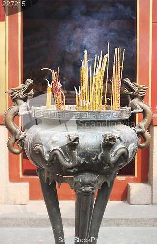 Image of Burning incense sticks at a temple.