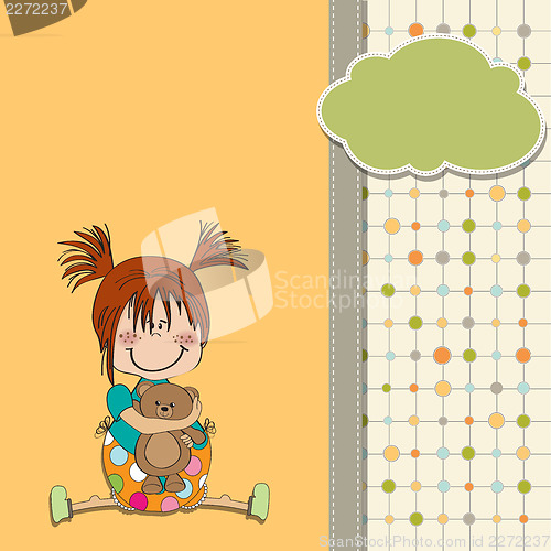Image of little girl sitting with her teddy bear