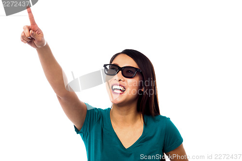 Image of Jolly female model pointing at something