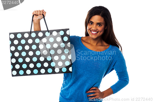 Image of Pretty young model posing with shopping bag