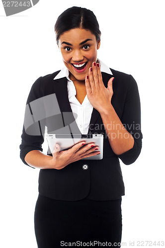 Image of Excited businesswoman holding touch pad