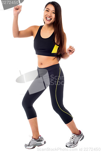 Image of Cheerful fitness trainer dancing in joy