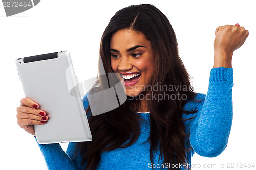 Image of Excited woman holding touch pad