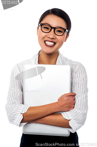Image of Female secretary holding laptop tightly