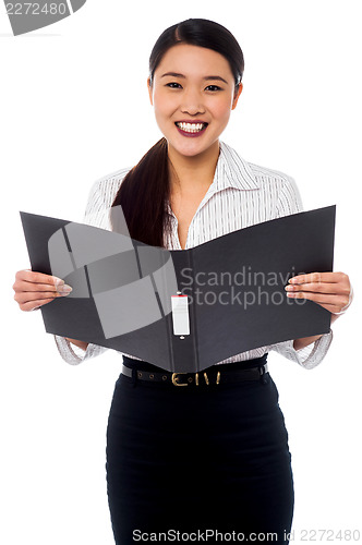 Image of Female assistant reviewing file