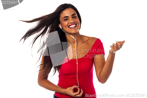 Image of Cheerful girl enjoying music madly