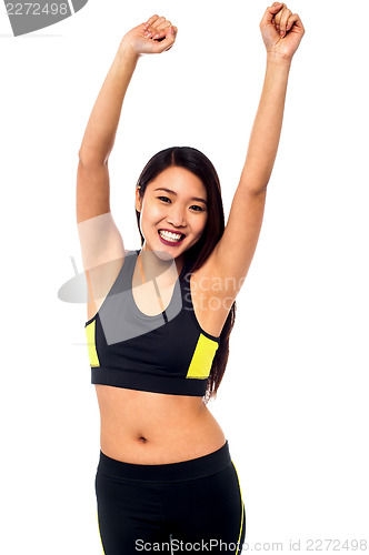Image of Joyous female raising arms in excitement