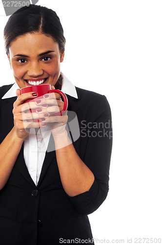 Image of Woman enjoying coffee during work break