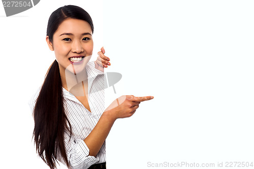 Image of Business lady pointing towards ad on billboard