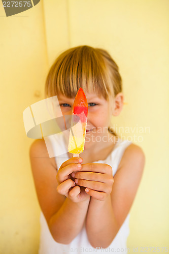 Image of Young girl holding up popsicle