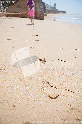 Image of Young girl walking on beach