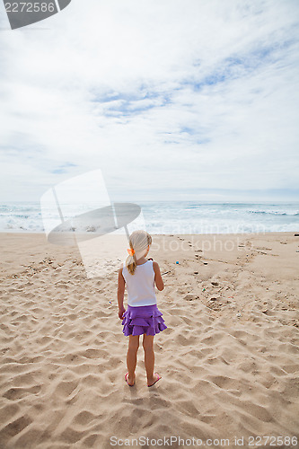 Image of Young girl standing at beach
