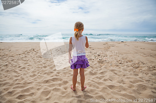 Image of Young girl standing at beach