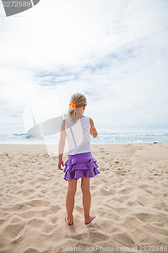 Image of Young girl standing at beach