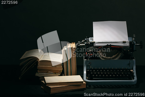 Image of Old typewriter with books retro colors on the desk