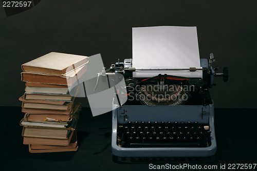 Image of Old typewriter with books retro colors on the desk