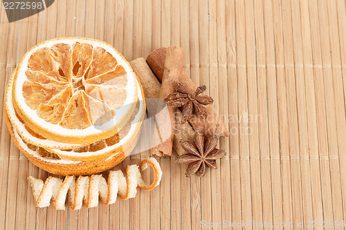 Image of Star Anise, cinnamon and dried orange wooden background 