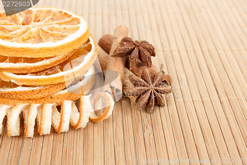 Image of Star Anise, cinnamon and dried orange wooden background 