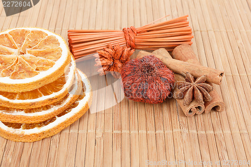 Image of Star Anise, cinnamon and dried orange wooden background 