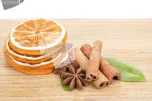 Image of Star Anise, cinnamon and dried orange wooden background 