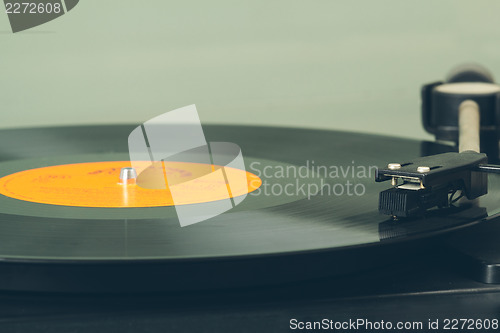 Image of Spinning vinyl record. Motion blur image.  Vintage toned. 