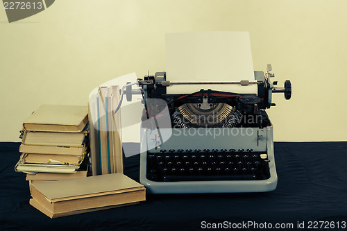 Image of Old typewriter with books retro colors on the desk