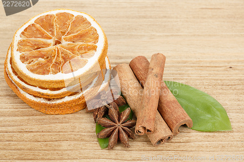 Image of Star Anise, cinnamon and dried orange wooden background 